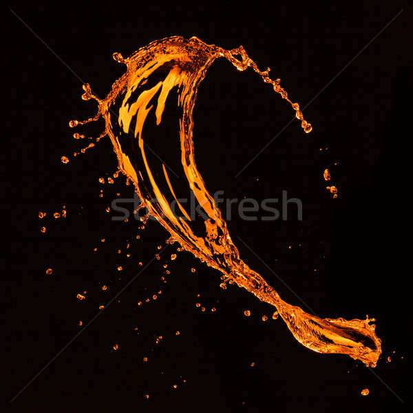 orange water splash isolated on black Stock photo © artjazz