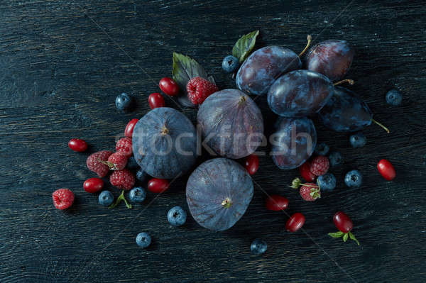 ripe figs and berries with a bunch of basil Stock photo © artjazz