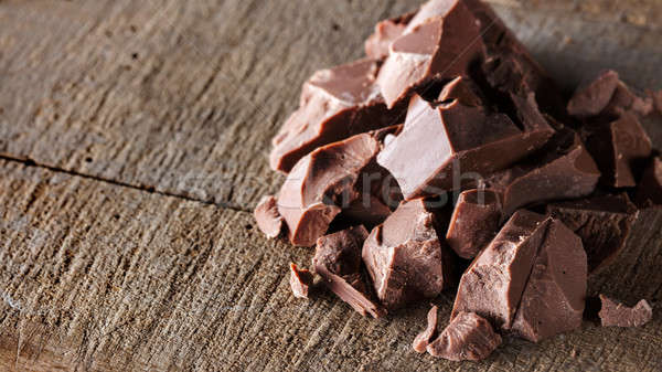 Pieces of milk Chocolate on wood Stock photo © artjazz