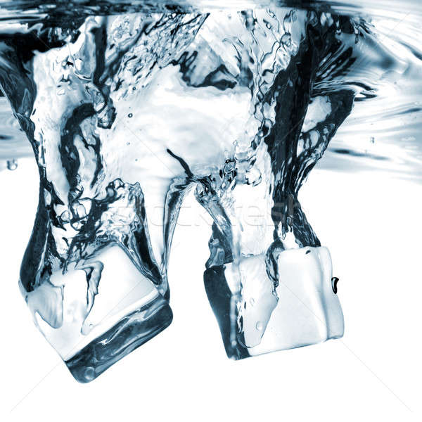 Stock photo: ice cubes dropped into water with splash isolated on white