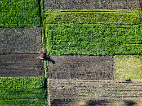 Stock photo: Aerial view of tractor pulling drill sowing seed In field