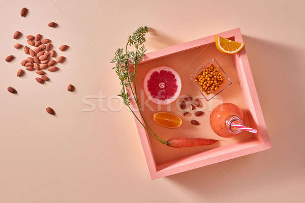 Homemade natural organic smoothie, made with grapefruits, orange, berries, carrots and nuts in glass Stock photo © artjazz