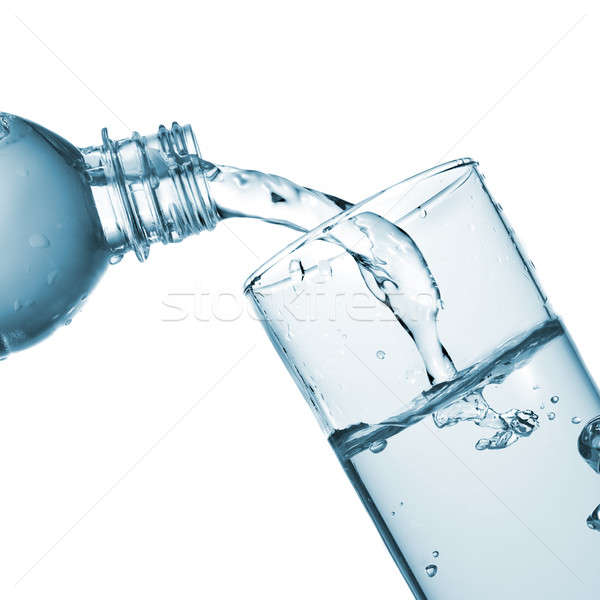 Stock photo: water pouring into glass from bottle isolated on white