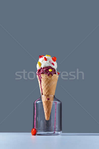The waffle cone stands in glass jar with a ball of berry and van Stock photo © artjazz