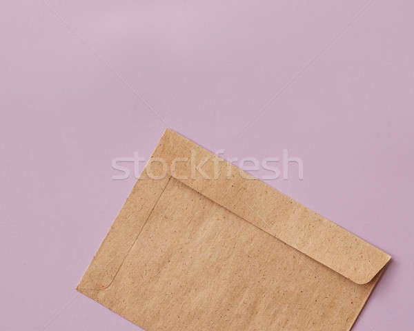 Brown craft envelope for mailing on pink background Stock photo © artjazz