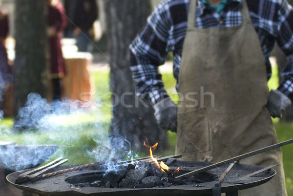 Smith against fireplace with instruments Stock photo © artjazz