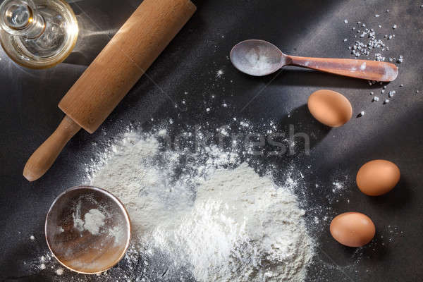 flour and ingridients on black table Stock photo © artjazz