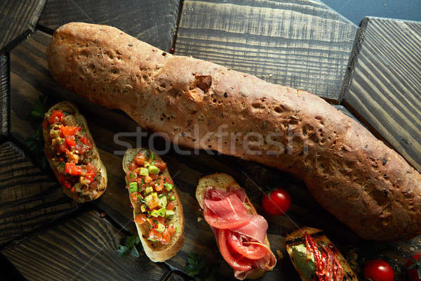 mini bruschetta with tomatoes, salmon, avocado, bacon, and basil butter Stock photo © artjazz