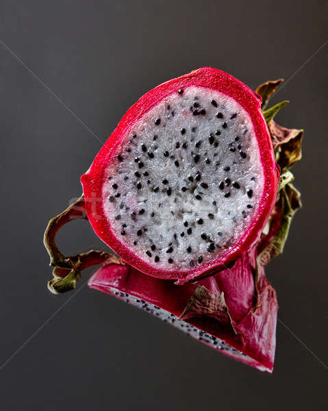 Exotic fruit Pitahaya isolated on a black glossy background Stock photo © artjazz