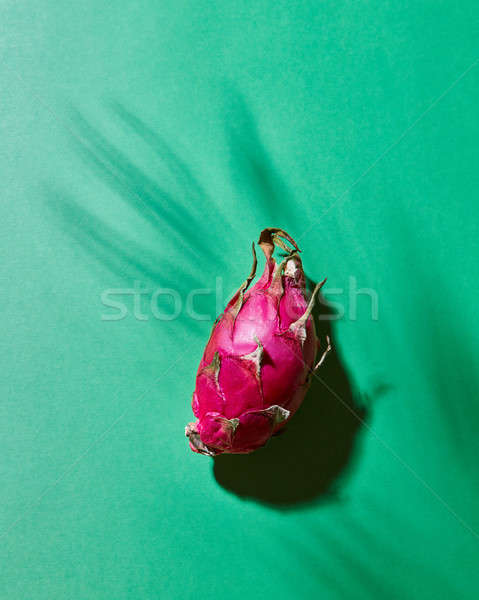 Pink pitahaya on a green background with a shadow Stock photo © artjazz