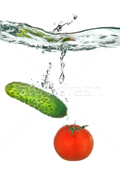 red tomato and green cucumber dropped into water isolated on white Stock photo © artjazz