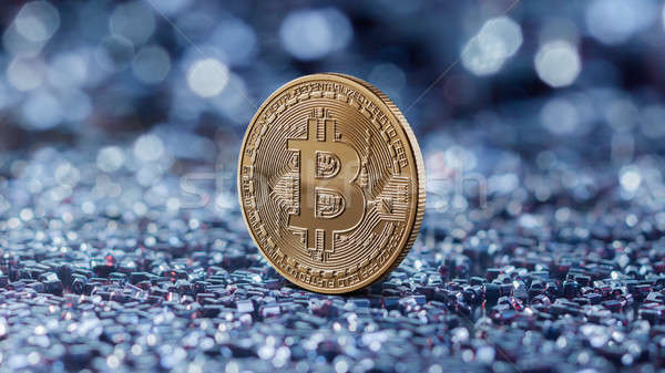 Gold coin bitcoin on a blue blurred background Stock photo © artjazz