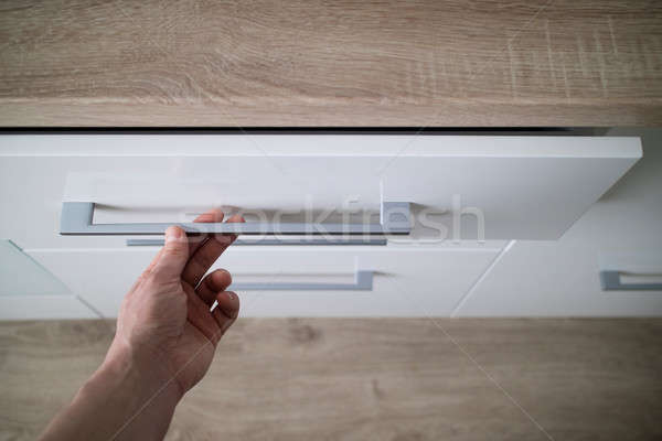 man hand opening white dishwasher on the kithen Stock photo © artjazz