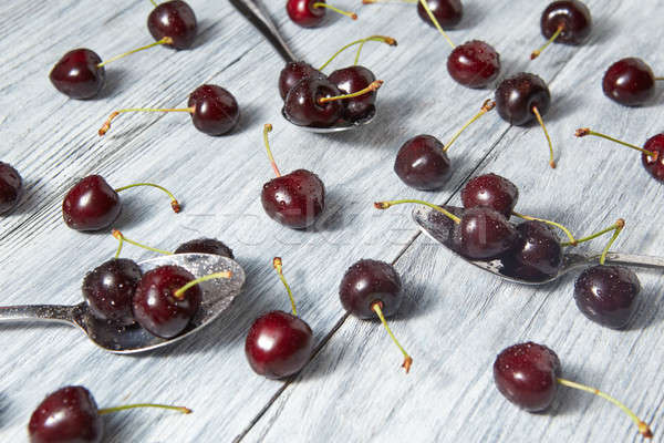 Healthy organic food - ripe red cherries on gray table. Concept of vegetarian food. Stock photo © artjazz