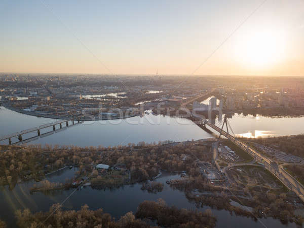 Stock photo: Bridge over the Dnieper River at sunset, the city of Kiev in the distance