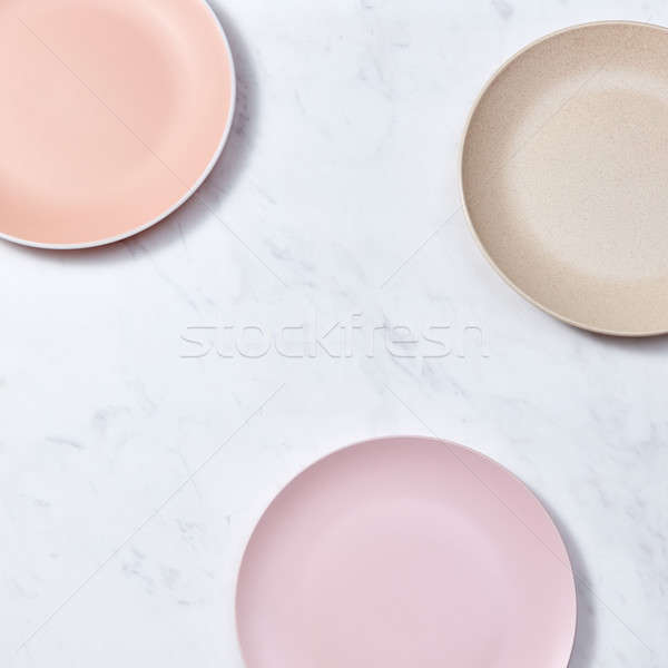 Traditional decorative ceramic handcraft plates covered with glazed on a gray background. Flat lay Stock photo © artjazz