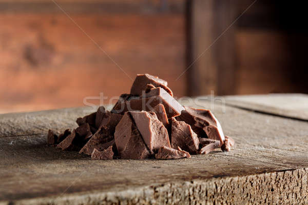 Stock photo: Pieces of milk Chocolate on wood