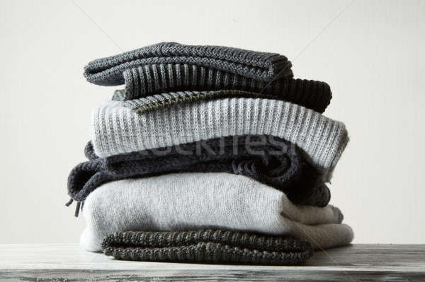 Pile of knitted winter clothes on background Stock photo © artjazz