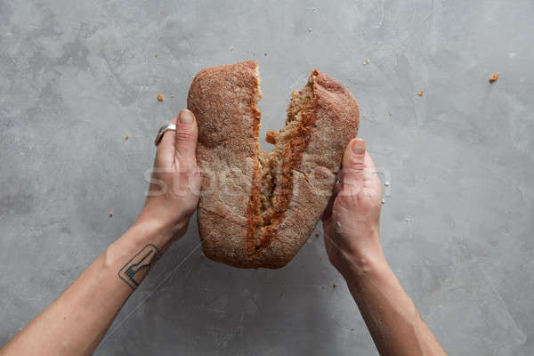 Hand breaks bread Stock photo © artjazz