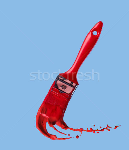 red paintbrush isolated on a blue background Stock photo © artjazz