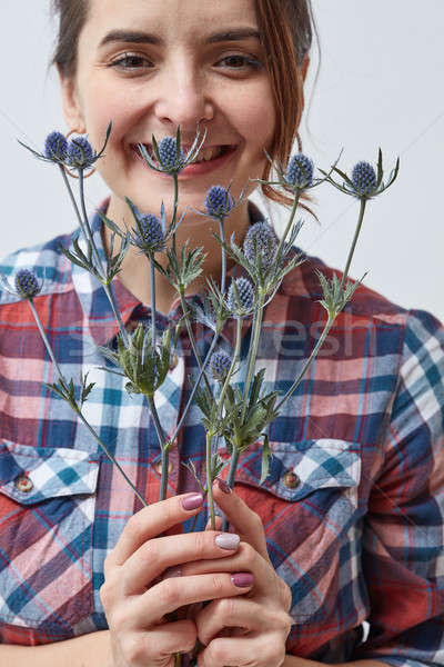 Stock photo: Young girl with flowers eryngium