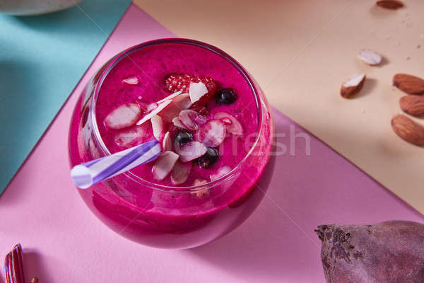 Smoothies of red berries in a glass with a beetroot, raspberries and black currants, almonds on a pa Stock photo © artjazz