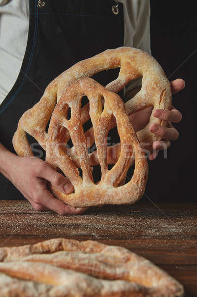 Baker is holding fougas bread Stock photo © artjazz