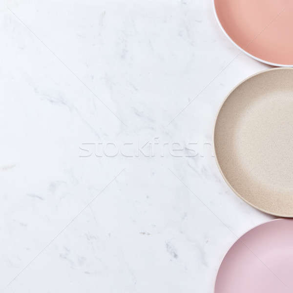 Corner frame with porcelain empty plates on a gray marble table. Pastel colored ceramic vintage hand Stock photo © artjazz