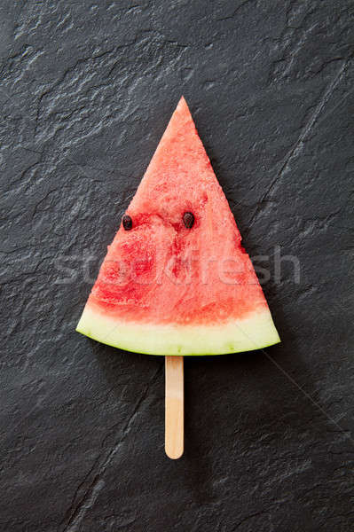 A composition of sweet piece of watermelon on a black concrete background. A piece of watermelon in  Stock photo © artjazz