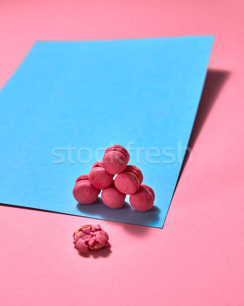 Original composition of colorful macaroons on a blue pink paper background Stock photo © artjazz