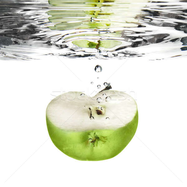 green apple dropped into water with bubbles isolated on white Stock photo © artjazz
