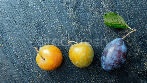 three plums on a black background Stock photo © artjazz