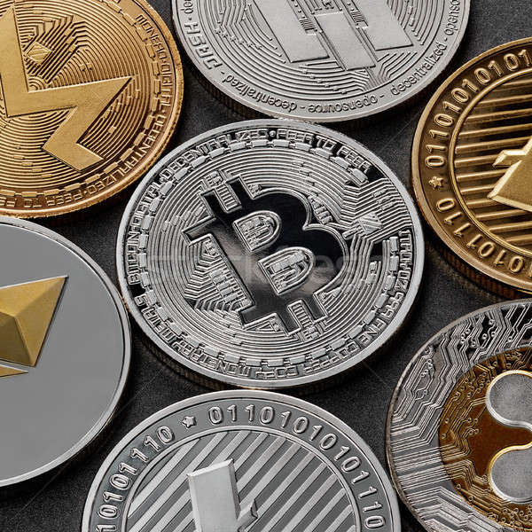 Different coins of crypto currency on a black background. Business concept. Stock photo © artjazz