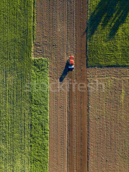 Aerial view of the tractor in the field, spring sowing work. Stock photo © artjazz