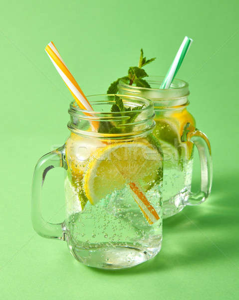 Two mason jars with a cold natural handmade cocktail with bubble Stock photo © artjazz