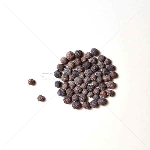 Whole aromatic allspice roung pattern isolated on white background. Stock photo © artjazz