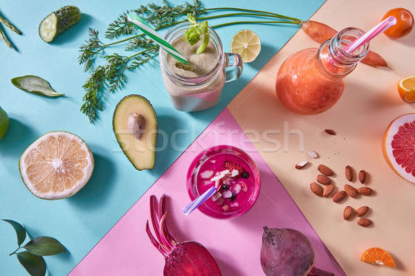 Orange, green and red smoothies from colorful natural vegetables and fruits in a glass bottles with  Stock photo © artjazz
