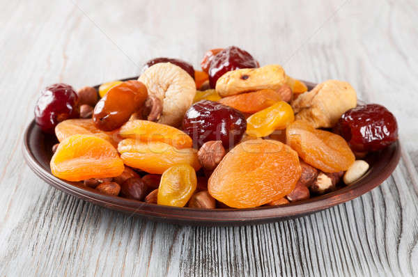Fruits and nuts in plate Stock photo © Artspace