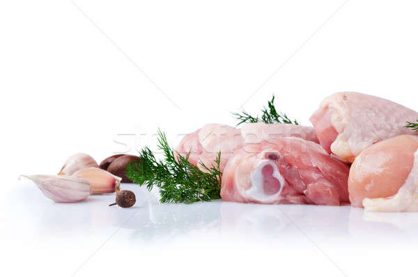 Raw chicken legs with garlic cloves Stock photo © Artspace