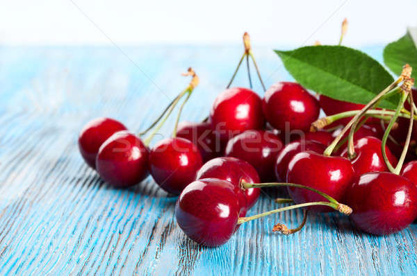 Red sweet cherry and green leaves Stock photo © Artspace