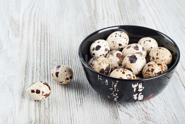 Quail eggs in a black dish Stock photo © Artspace
