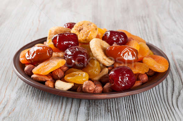 Dried Fruits and nuts in plate Stock photo © Artspace