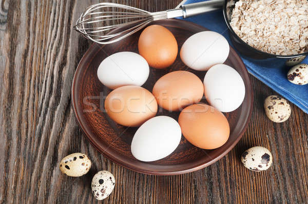 Quail and chicken eggs in a clay plate Stock photo © Artspace
