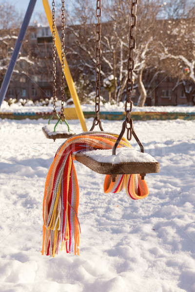 Empty swing with snow and checkered scarf  Stock photo © artsvitlyna