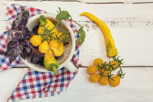 Amarelo quente pimenta tomates roxo manjericão Foto stock © artsvitlyna