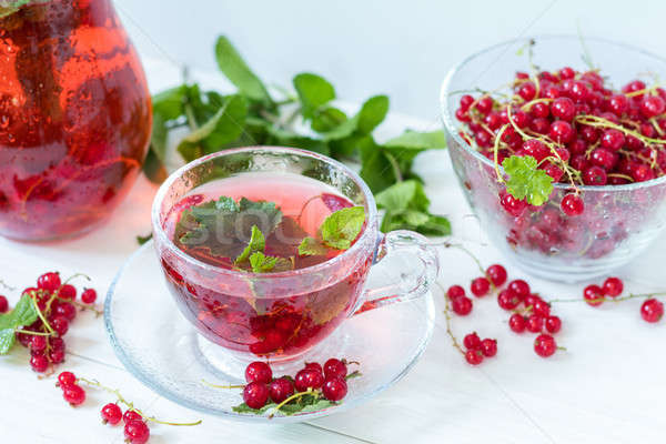 Redcurrant drink in transparent glass carafe and cup. Clear glas Stock photo © artsvitlyna