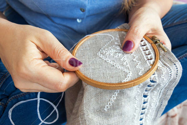 Woman hands doing openwork embroidery on homespun linen.  Stock photo © artsvitlyna