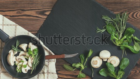 Top view of fresh mushrooms with mash salad and rosemary on a da Stock photo © artsvitlyna