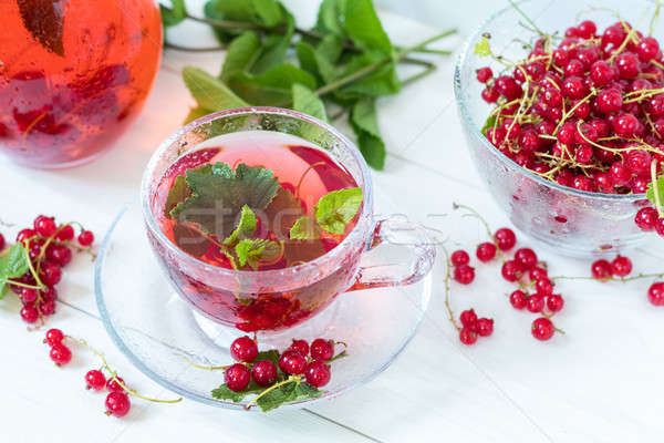 Redcurrant drink in transparent glass carafe and cup Stock photo © artsvitlyna