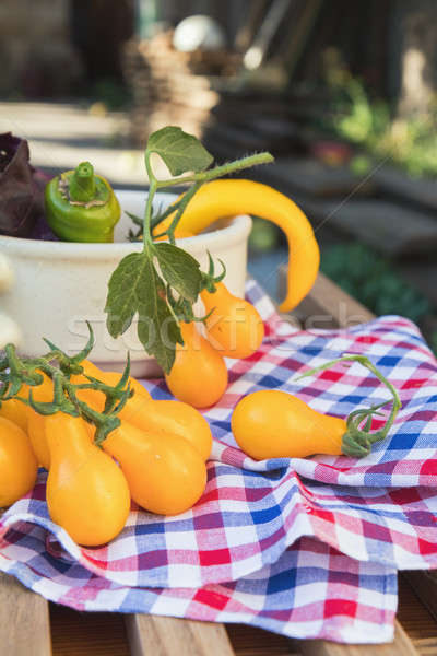 Yellow hot pepper and yellow tomatoes with purple basil Stock photo © artsvitlyna